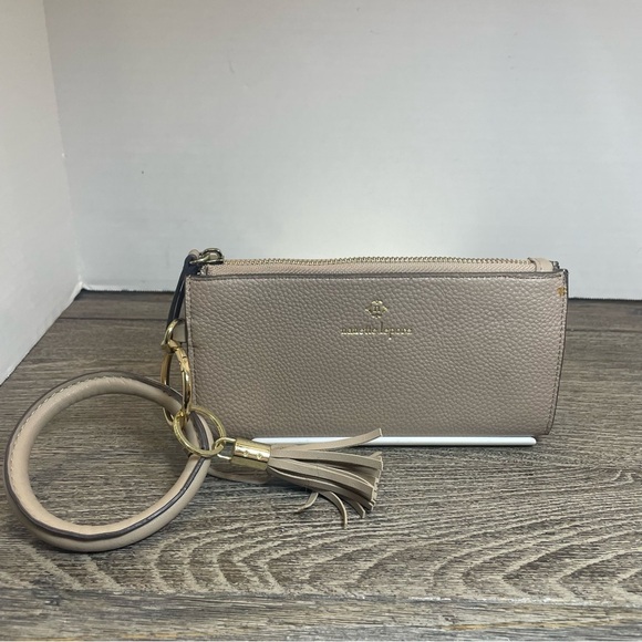 Nanette Lepore Handbags - Nanette lepore Tan Clutch with Tassel Accent wristlet. Small flaw on corner